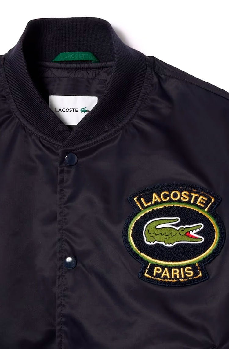 Jaqueta Lacoste Bomber Acolchoada Impermeável com Emblema Azul Marinho - NewSkull